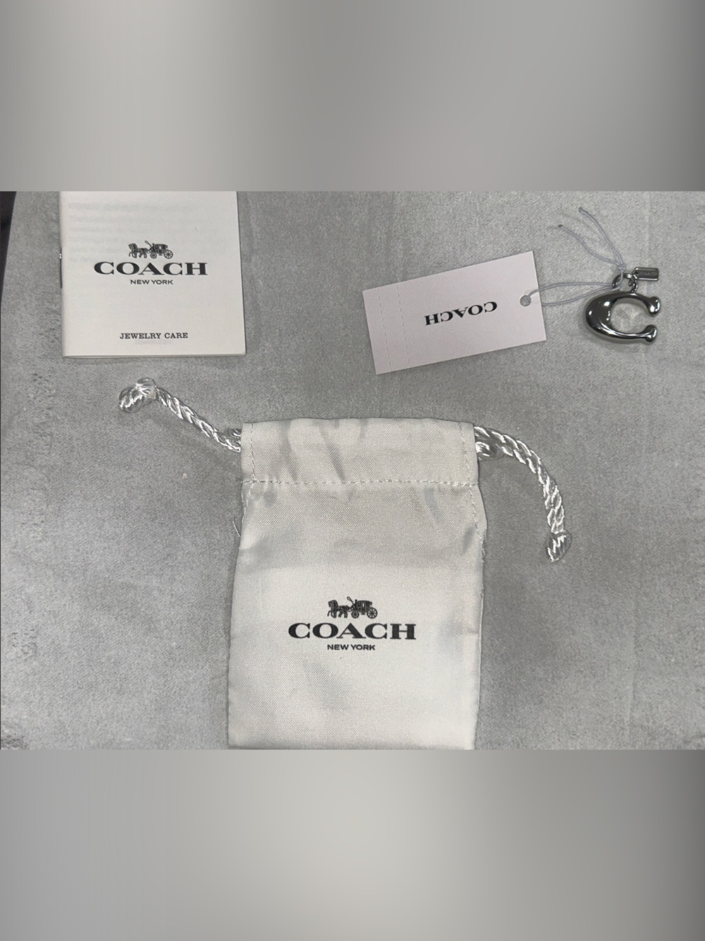 Coach Silver-Tone 'C' Charm with  care booklet, tag and Dust Bag. NWT